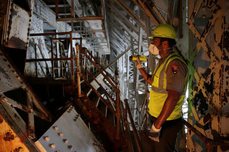 FILE PHOTO -- Aaron LaRocca, Chief of Staff of the George Washington Memorial Parkway, looks at a trunnion post that needs replacement under the draw span on the Arlington Memorial Bridge in Washington, U.S., June 20, 2016. REUTERS/Joshua Roberts/File Photo