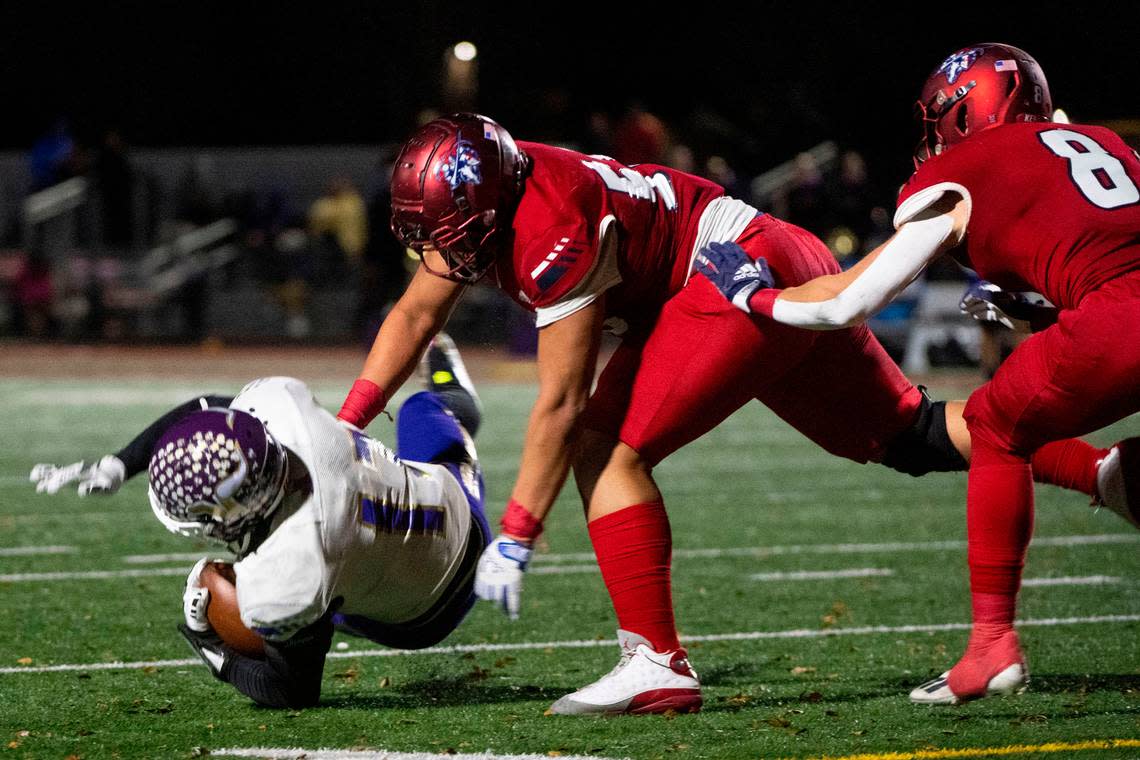 Kennedy Catholic’s Micah Banuelos throws Lake Stevens running back Jayden Limar to the ground in the backfield for a loss during the third quarter of the Class 4A state championship game on Saturday, Dec. 3, 2022, at Mount Tahoma High School in Tacoma, Wash.