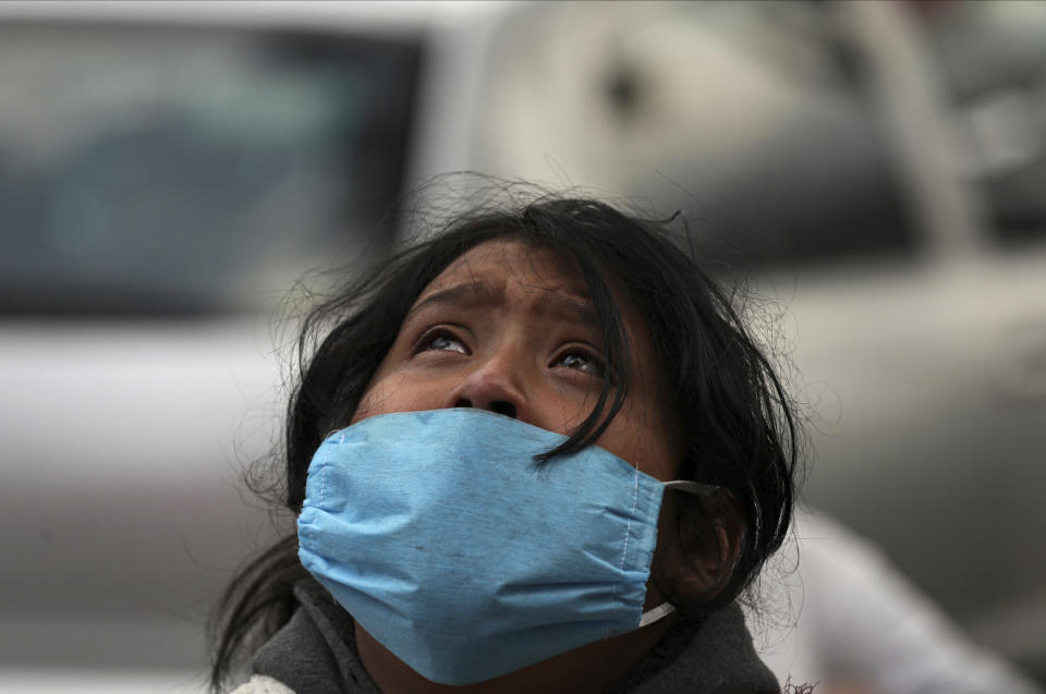 FILE - In this April 29, 2020 file photo, Aurora Azamar reacts after learning that her mother died, believed from complications related to the coronavirus, outside a public hospital in the Iztapalapa neighborhood of Mexico City. As Mexico approaches 200,000 in officially test-confirmed deaths from COVID-19, the real death toll is probably higher due to the country’s extremely low rate of testing. (AP Photo/Fernando Llano, File)