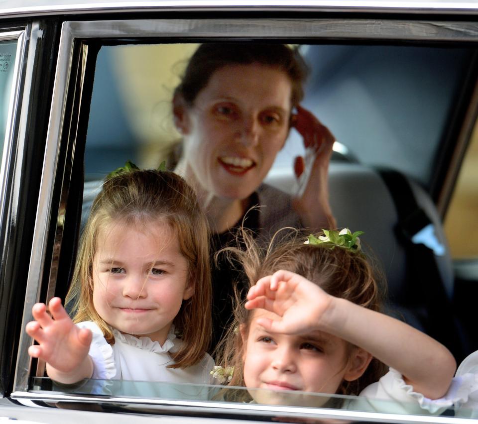 Princess Charlotte of Cambridge and Theodora Williams, (accompanied by Princess Charlotte's nanny Maria Teresa Turrion Borrallo) attend the wedding of Princess Eugenie of York and Jack Brooksbank at St George's Chapel on October 12, 2018 in Windsor, England.