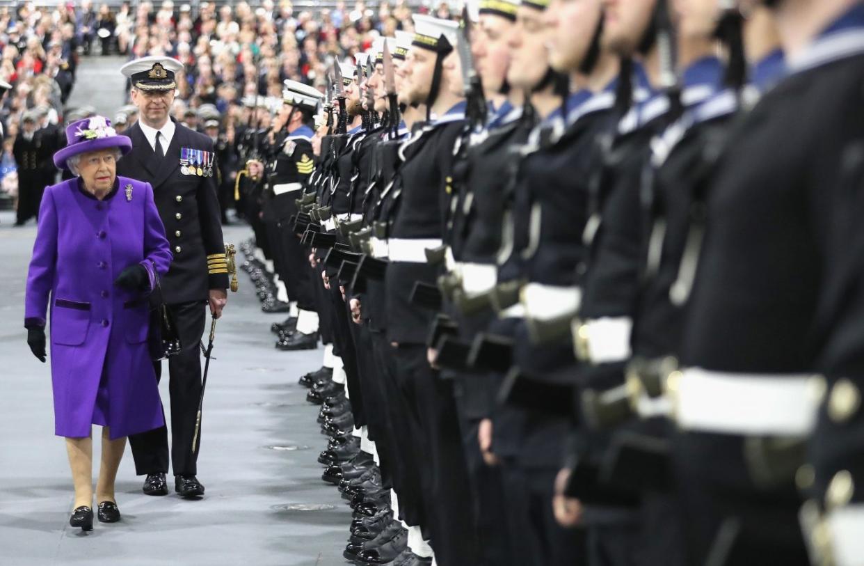 The Queen walks with the ship's captain Jerry Kyd, as she inspects members of the ship's company (PA)