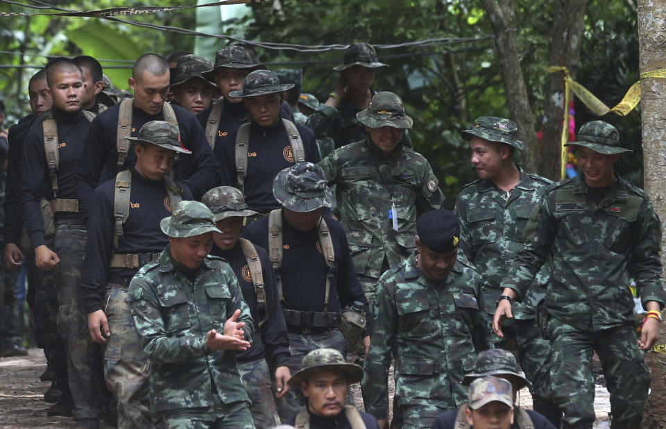 Thai soldiers makes their way down at the entrance to a cave complex. Source: AP