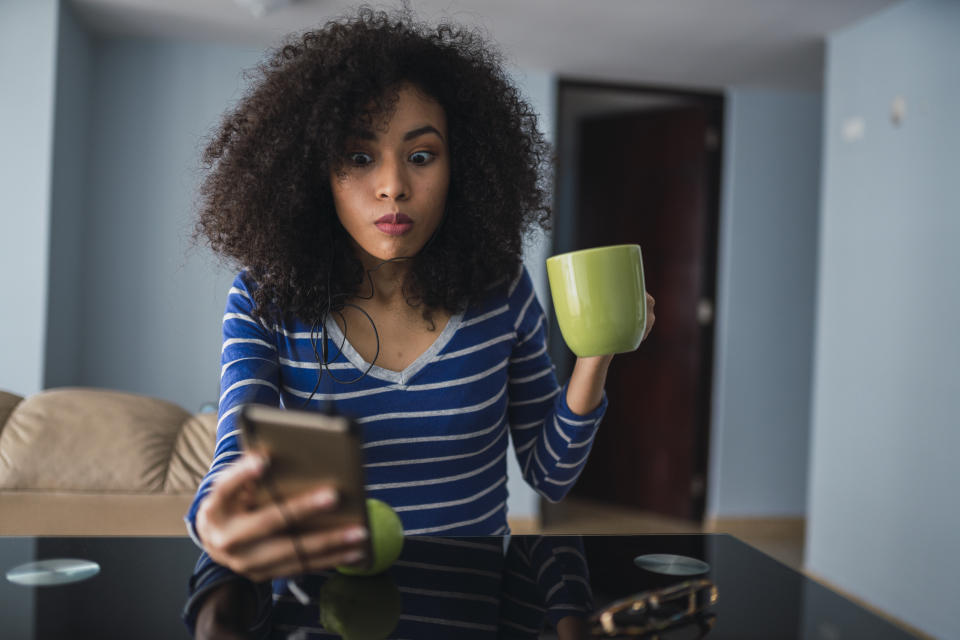 Woman checking iOS 15 updates on Safari.