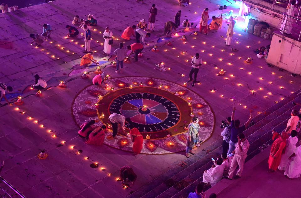 Hindu devotees light earthen lamps on the banks of the River Sarayu on the eve before the groundbreaking ceremony of the proposed Ram Temple in Ayodhya on August 4, 2020. - India's Prime Minister Narendra Modi will lay the foundation stone for a grand Hindu temple in a highly anticipated ceremony at a holy site that was bitterly contested by Muslims, officials said. The Supreme Court ruled in November 2019 that a temple could be built in Ayodhya, where Hindu zealots demolished a 460-year-old mosque in 1992. (Photo by SANJAY KANOJIA / AFP) (Photo by SANJAY KANOJIA/AFP via Getty Images)