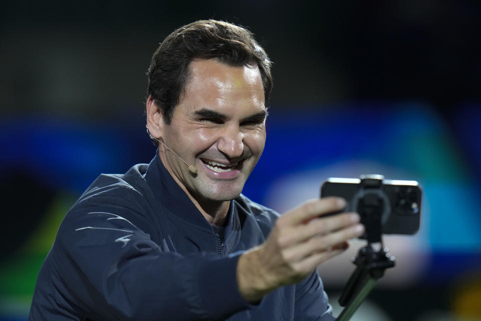 Retired tennis player Roger Federer takes a selfie with spectators during a Federer's fan day, a side event of the Shanghai Masters tennis tournament at Qizhong Forest Sports City Tennis Center in Shanghai, China, Friday, Oct. 13, 2023. (AP Photo/Andy Wong)
