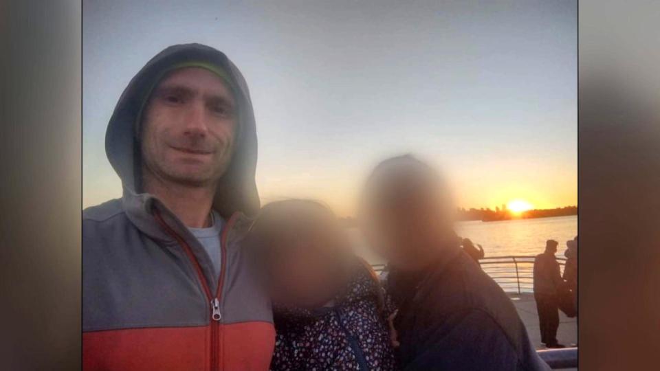 Paul Schmidt, left, poses for a photo with his wife and three-and-a-half-year-old daughter, whose faces have been blurred for privacy reasons. Police have identified Schmidt, 37, as the man who was fatally stabbed outside a Starbucks Sunday evening.