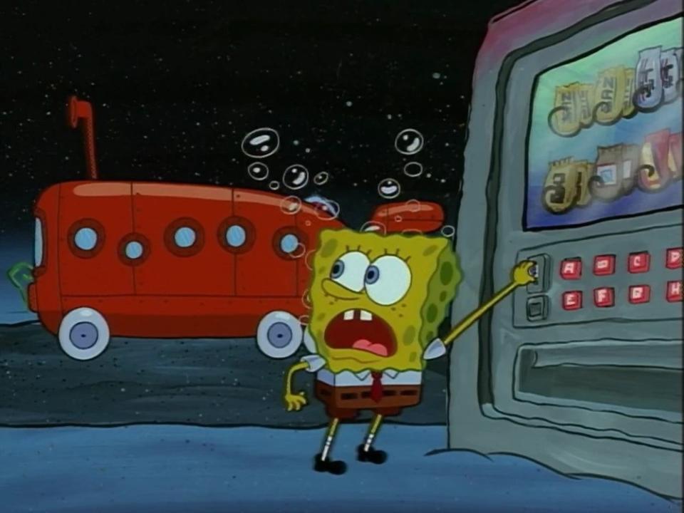 SpongeBob SquarePants standing confused in front of a bus stop at night