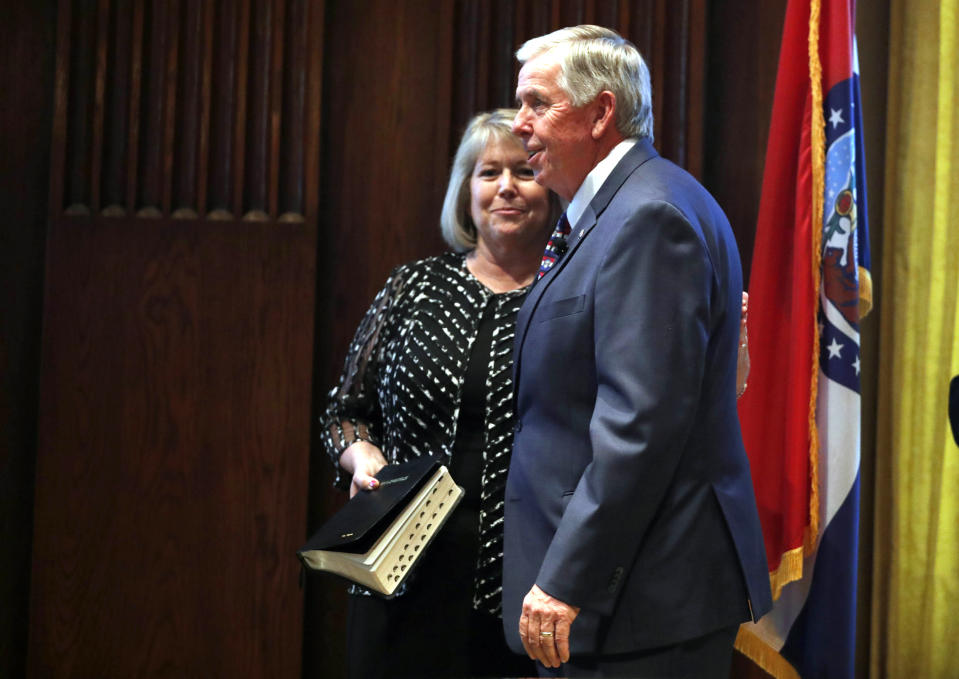 FILE - In this June 1, 2018 file photo, Gov. Mike Parson, right, smiles along side his wife, Teresa, after being sworn in as Missouri's 57th governor in Jefferson City, Mo. Teresa Parson has tested positive for the coronavirus after experiencing mild symptoms, a spokeswoman for the governor said Wednesday, Sept. 23, 2020. (AP Photo/Jeff Roberson, File)