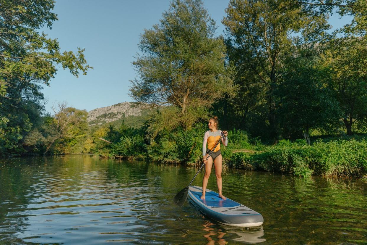 Woman using a stand-up paddleboard