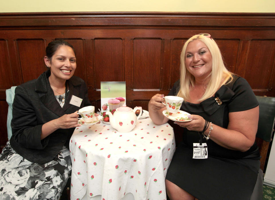 Vanessa Feltz (left) sips tea with newly elected Witham MP Priti Patel during an event supporting Breast Cancer Care's Strawberry Tea fundraising campaign at the Houses of Parliament, Westminster, London.