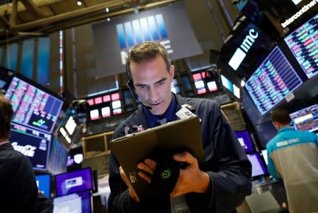 Traders work on the floor at the NYSE in New York