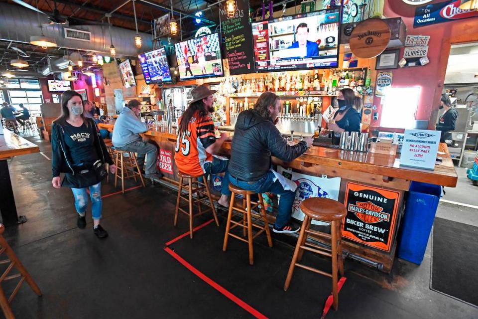 Customers eat at the bar at Mac’s Speed Shop on South Boulevard on March 15. Mac’s Hospitality Group has seen a 520% increase in takeout and delivery during the coronavirus pandemic.