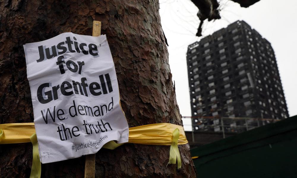 A sign pinned to a tree near Grenfell Tower