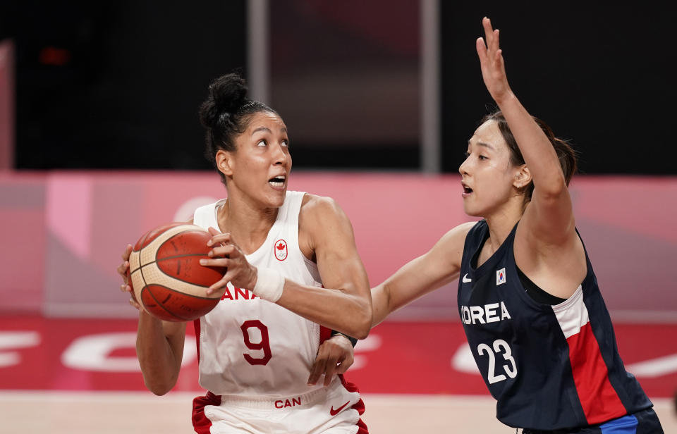 Canada's Miranda Ayim (9), left, drives to the basket past South Korea's Danbi Kim (23) during women's basketball preliminary round game at the 2020 Summer Olympics, Thursday, July 29, 2021, in Saitama, Japan. (AP Photo/Charlie Neibergall)