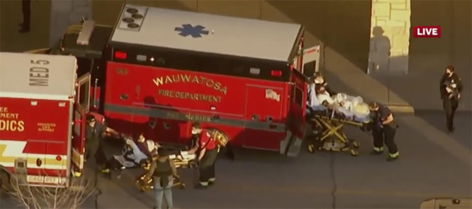 In this image taken from video provided by WISN-TV, emergency crews place two people in waiting ambulances at the Mayfair Mall in Wauwatosa, Wis., on Friday, Nov. 20, 2020. A police dispatcher says officers are responding to "a very active situation" at the suburban Milwaukee mall. The dispatcher said she could not immediately provide further details. Witnesses told WISN-TV that they heard what they believed were eight to 12 shots. (WISN-TV via AP)