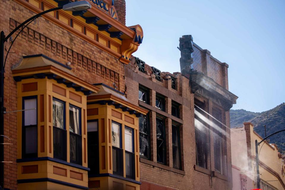 Firefighters hose down a building on Main St. in Bisbee, AZ on Feb. 15, 2024.