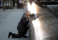 Robert Peraza, who lost his son Robert David Peraza in the attacks at the World Trade Center, pauses at his son's name at the North Pool of the 9/11 Memorial before the 10th anniversary ceremony at the site, Sunday Sept. 11, 2011, in New York. (AP Photo/Justin Lane, Pool)