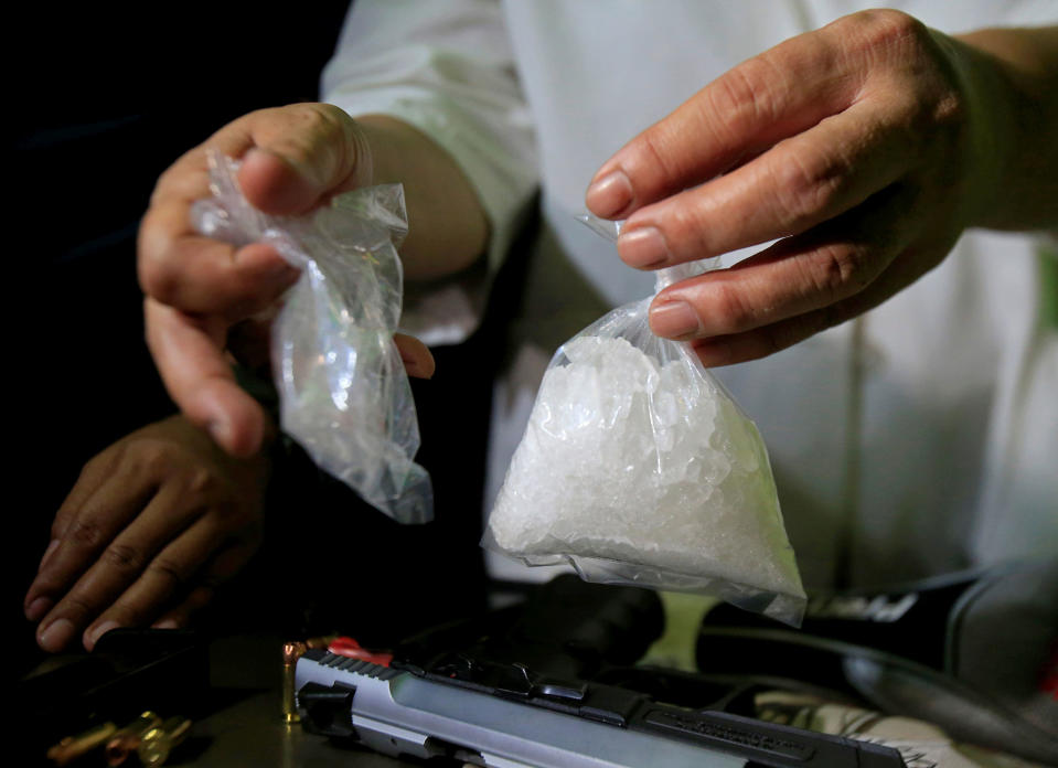 <p>A bag of a methamphetamine, known as shabu, is shown by a National Bureau of Investigation agent after a raid on the home of a police officer and member of the anti-drugs unit in metro Manila, Philippines on May 25, 2016. (REUTERS/Romeo Ranoco) </p>