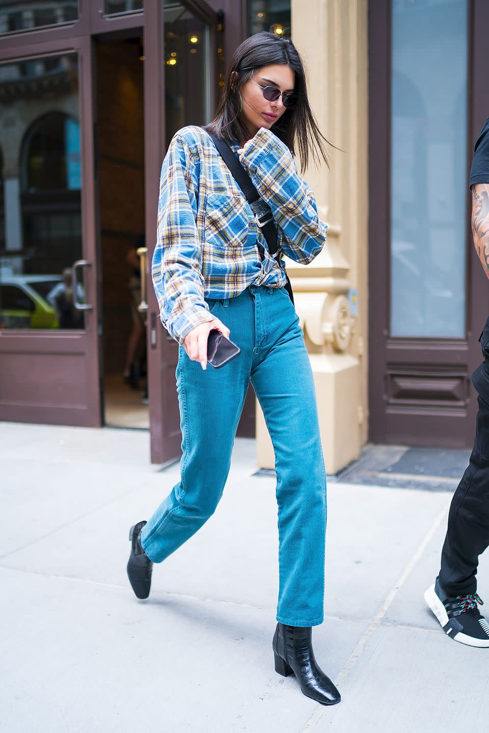 <p>The model wore a relaxed plaid shirt whilst out in New York.</p>