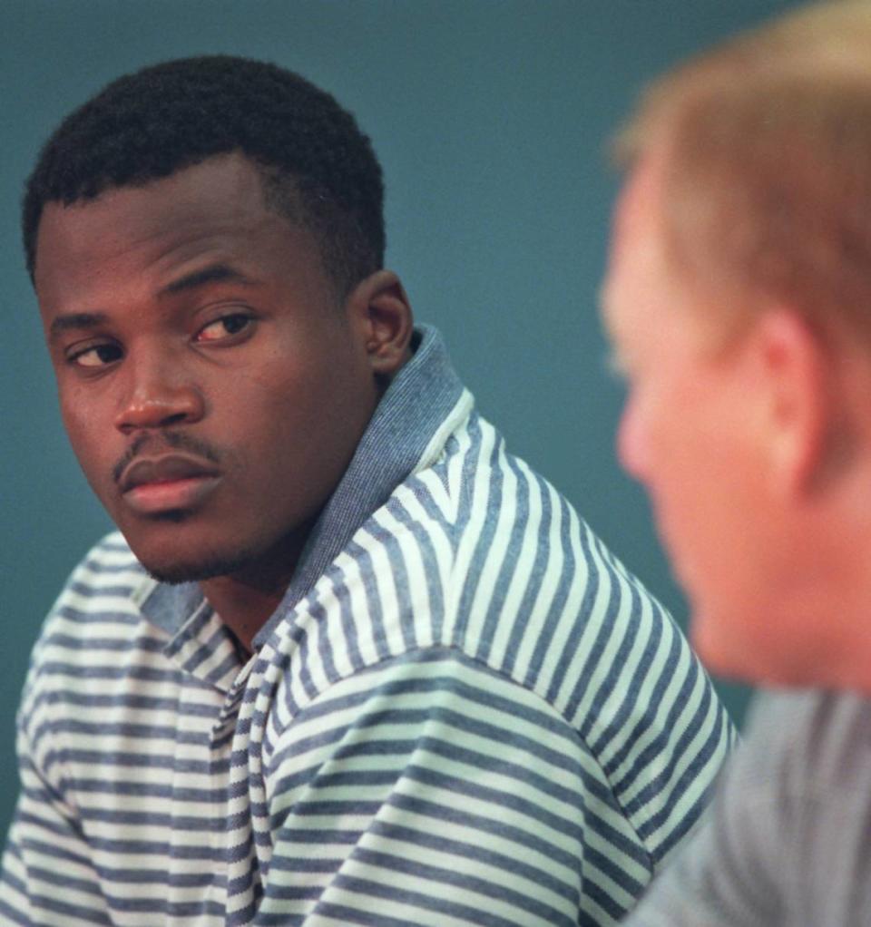 8/17/96 1B: FOR PUBLISHED CUTLINE / CAPTION, SEE VUTEXT SAVE. **UNPUBLISHED NOTES : ** (CHANDLER 8/16/96) Newly signed and in camp, Panther running back Tim Biakabatuka looks at general manger Bill Polian during a news conference Friday night.