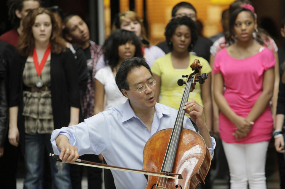 World-famous cellist Yo-Yo Ma plays with famed soprano Renee Fleming and  a choir of dozens of high school students in the rotunda of the State of Illinois building, the James R. Thompson Center, Monday, March 19, 2012, in Chicago. The Monday afternoon performance was to promote the Chicago Symphony Orchestra's Citizen Musician initiative. The Lyric Opera of Chicago also sponsored the event and Illinois Gov. Pat Quinn attended. (AP Photo/Kiichiro Sato)