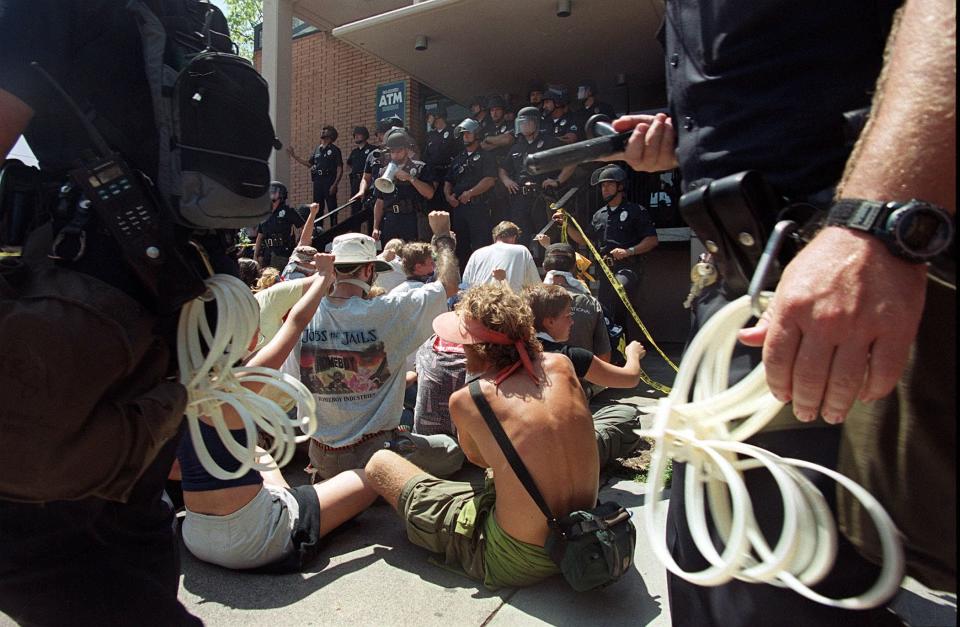Police prepare to arrest protesters blocking the entrance to the Rampart Division Police Station during a demonstration against police brutality Aug. 16, 2000, in Los Angeles, host city of the Democratic National Convention.