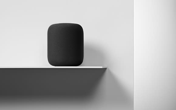 HomePod on a shelf.