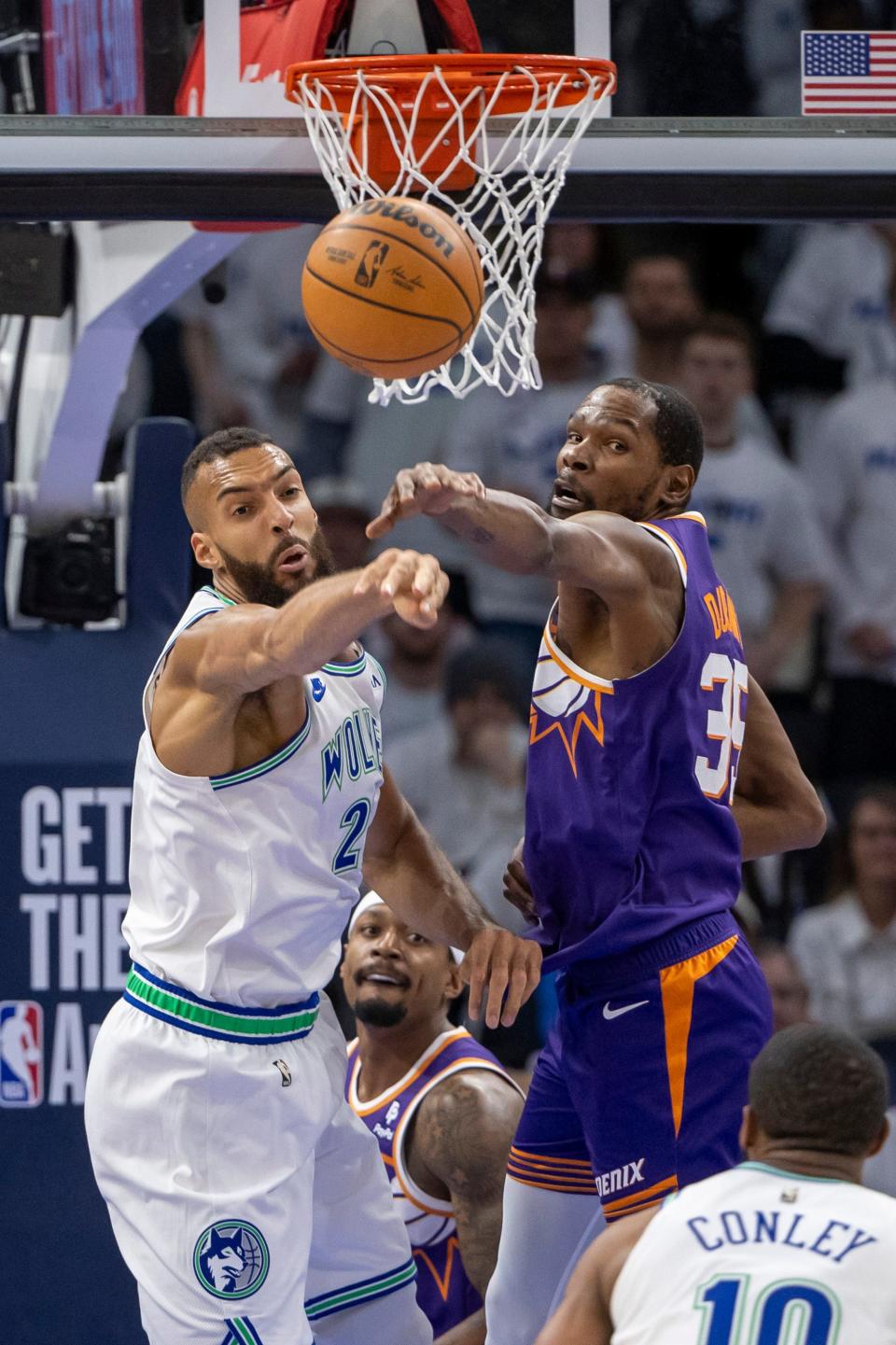 Minnesota Timberwolves center Rudy Gobert (27) and Phoenix Suns forward Kevin Durant (35) jump for a rebound in the first half during game one of the first round for the 2024 NBA playoffs at Target Center.