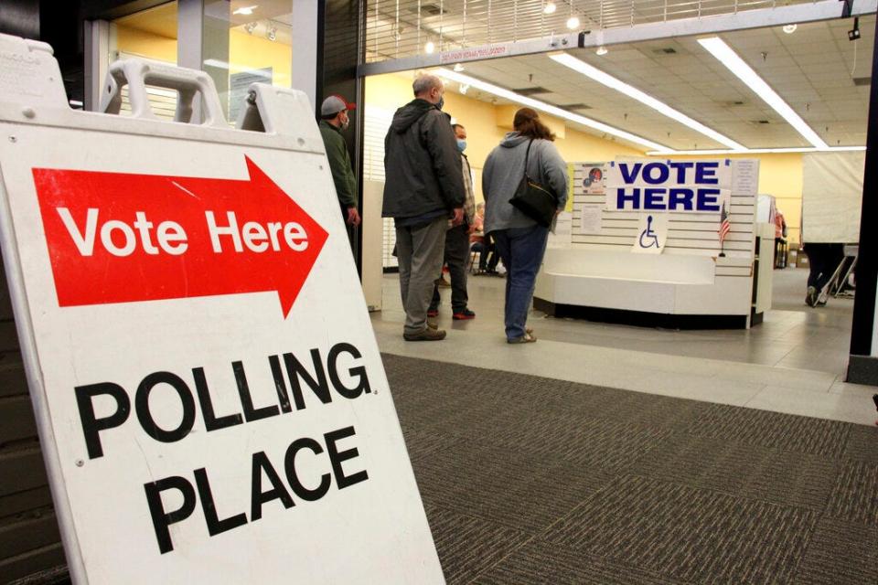 Residents in Anchorage, Alaska, take part in early voting in a mall in Alaska's largest city on Friday, Oct. 30, 2020. Alaska residents living in Juneau, Anchorage, Wasilla, Fairbanks and Nome can cast their votes early as designated locations. (AP Photo/Mark Thiessen)