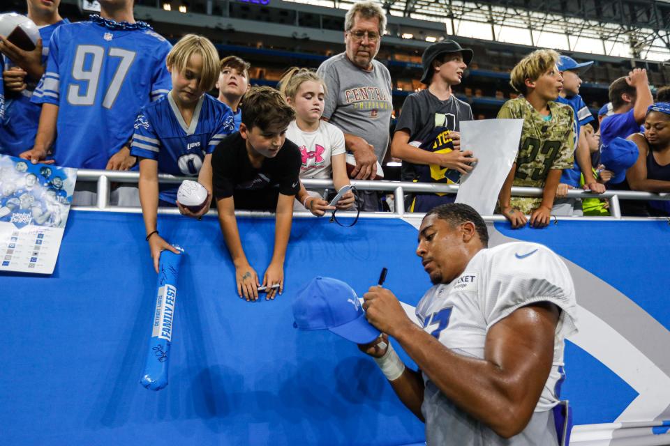 Lions linebacker Anthony Pittman signs autographs for fans after open practice at Family Fest at Ford Field on Saturday, August 6, 2022.