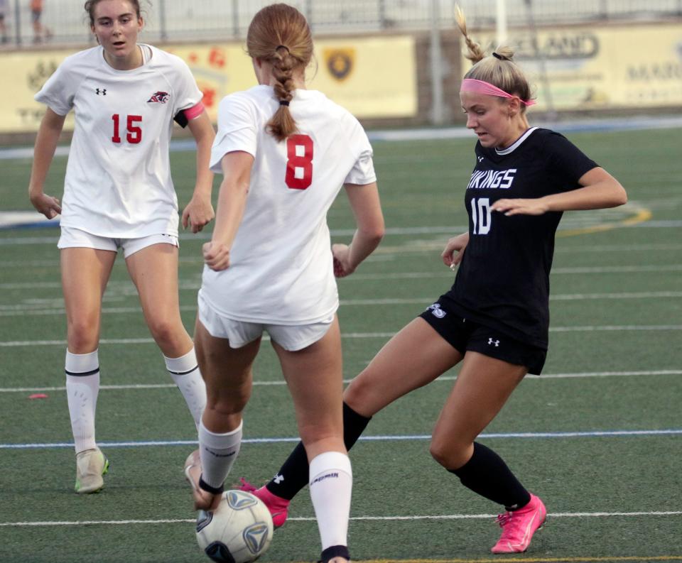 Lakeland Christian senior Carly Sabat tries to poke the ball away from All Saints senior Eliza Long on Thursday night in the Class 2A, District 7 championship match at Viking Stadium.