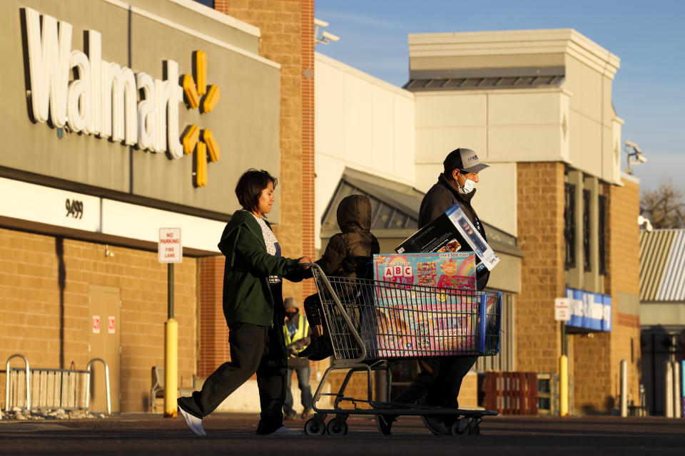 Customers pushing a cart out of Walmart