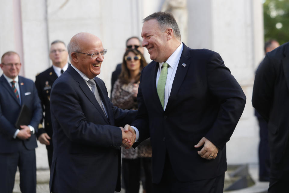 US Secretary of State Mike Pompeo, right, shakes hands with Portuguese Foreign Minister Augusto Santos Silva at the Foreign Ministry in Lisbon Thursday, Dec. 5, 2019. (AP Photo/Armando Franca)