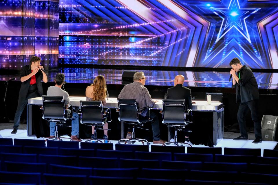 The Brothers Gage play their harmonicas for 'America's Got Talent' judges Simon Cowell, left with back to camera, Sofia Vergara, Eric Stonestreet and Howie Mandel and a sea of empty seats.