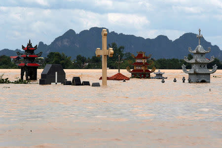 Submerged tombs are seen at a flooded village after heavy rainfall caused by tropical storm Son Tinh in Ninh Binh province, Vietnam. REUTERS/Kham