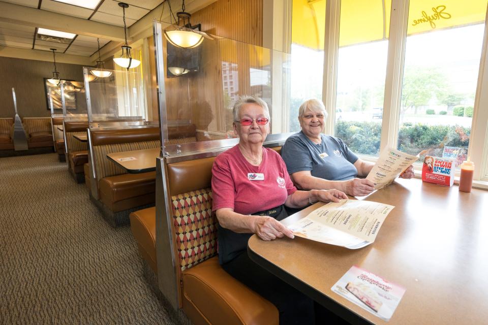 Longtime waitresses Wilma Mounce-Popp (left) and Terry Bell pose in a booth together at the Skyline Chili location on West Third Street in Covington, on April 24, 2023. Mounce-Popp, 70 years old, worked at the Covington location for nearly 50 years, and Bell, 63, had been there for 45.