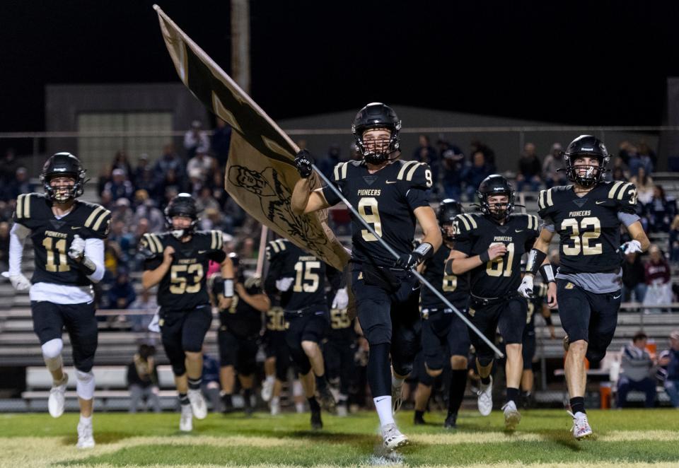 The Boonville football team takes the field ahead of its sectional game against the Reitz Panthers at Bennett Field in Boonville, Ind., Friday evening, Oct. 22, 2021.