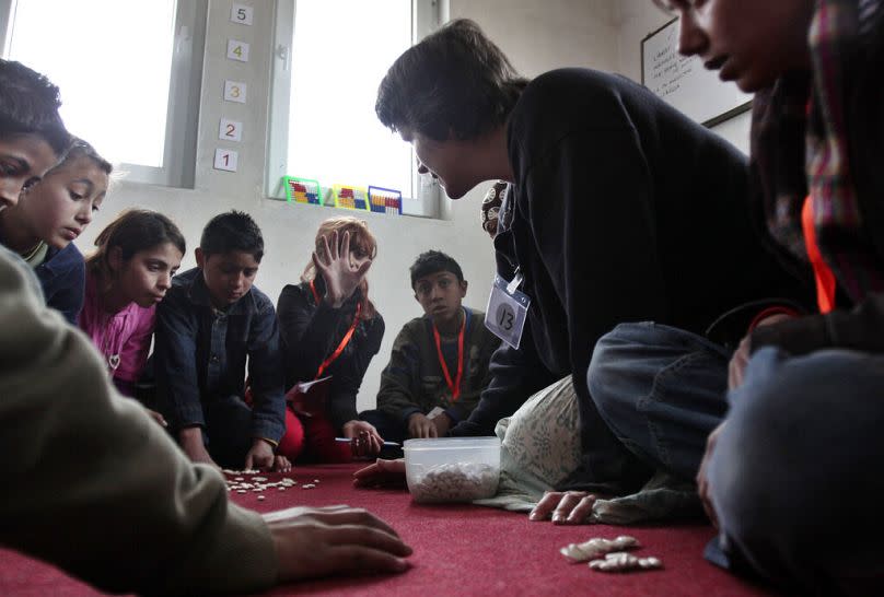 Kosovo Roma child answers to her teacher in the minority community makeshift learning center in the town of Kosovo Polje, April 2011