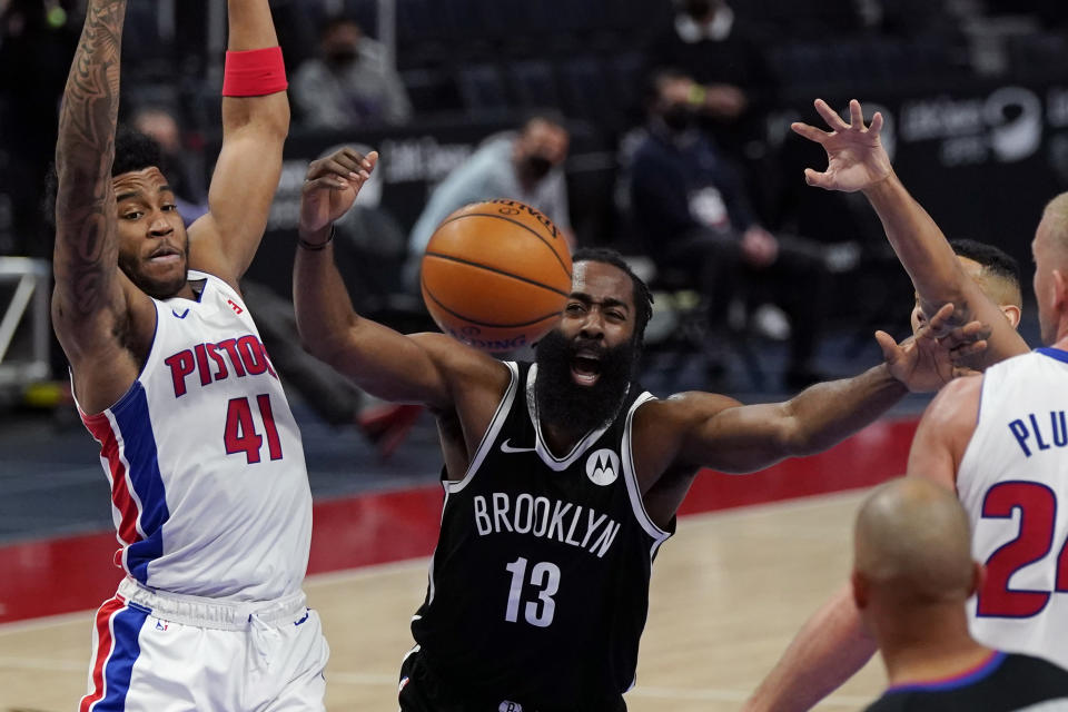 Brooklyn Nets guard James Harden (13) loses control of the ball between the defense of Detroit Pistons forward Saddiq Bey (41) and center Mason Plumlee (24) during the first half of an NBA basketball game, Friday, March 26, 2021, in Detroit. (AP Photo/Carlos Osorio)