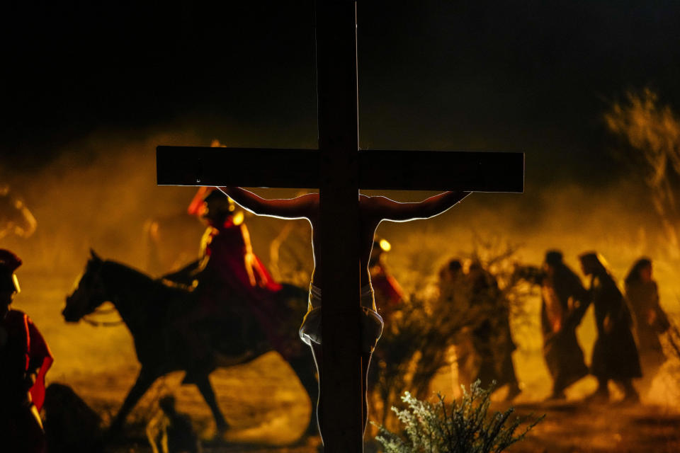 Faithful take part in a Way of the Cross reenactment, as part of Holy Week celebrations, in Colina, Chile, Friday, March 29, 2024. Holy Week commemorates the last week of Jesus' earthly life which culminates with his crucifixion on Good Friday and his resurrection on Easter Sunday. (AP Photo/Esteban Felix)