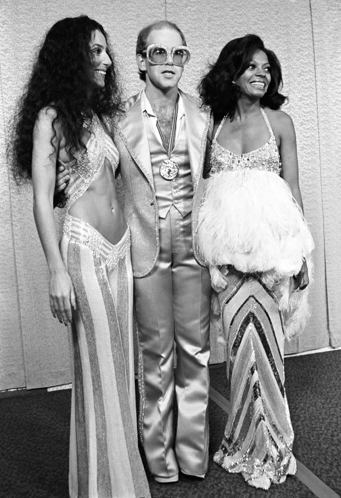 Actress/Singer Cher, Singer/Songwriter/Musician Elton John and Actress/Singer Diana Ross pose on the red carpet during the Rock Awards at the Santa Monica Civic Auditorium, Santa Monica, CA 1975. (Photo by Mark Sullivan/Getty Images)