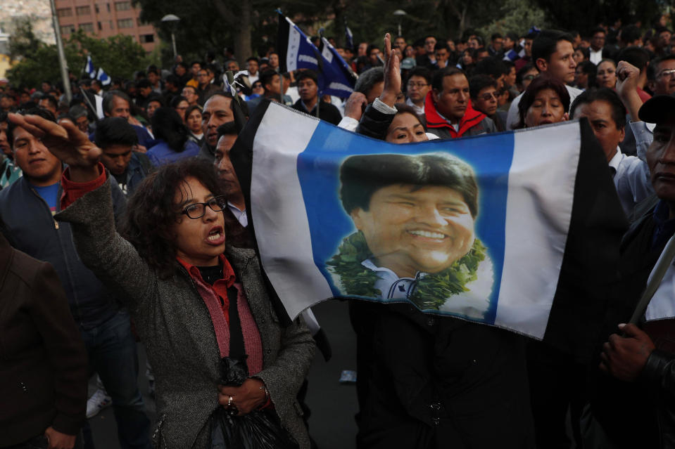 Supporters of Bolivian President Evo Morales, who is running for a fourth term, rally outside the Supreme Electoral Court where election ballots are being counted in La Paz, Bolivia, Monday, Oct. 21, 2019. A sudden halt in release of presidential election returns led to confusion and protests in Bolivia on Monday as opponents suggested officials were trying to help Morales avoid a risky runoff. (AP Photo/Juan Karita)