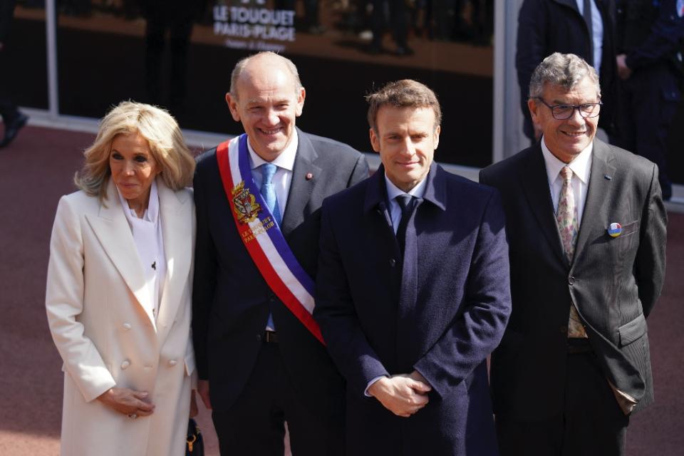 Brigitte Macron accompanies French President Emmanuel Macron to cast their ballot for the first round of France’s presidential election at a polling station in Le Touquet, France on April 10, 2022. - Credit: Sipa USA via AP
