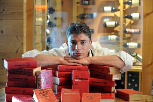 French chef Jean Sulpice, seen here posing with his collection of France's Michelin restaurant guides, in 2010, at his restaurant L'Oxalys, in Val-Thorens, up in the French Alps. The restaurant gained its second Michelin star on March 1, 2010