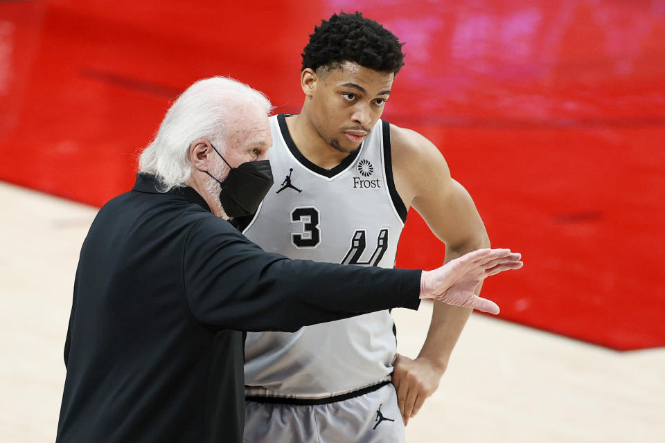 Keldon Johnson with coach Gregg Popovich.