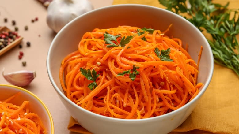 Grated carrots in white bowl