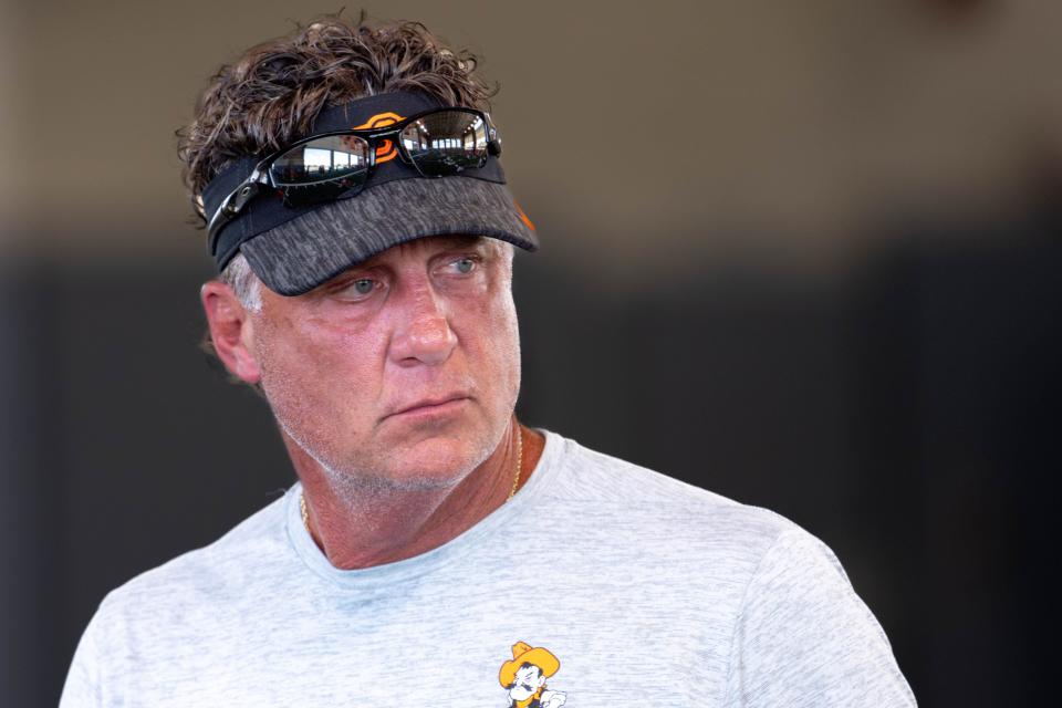 Head coach Mike Gundy walks on the field during an Oklahoma State football practice in Stillwater, Okla., on Wednesday, July 31, 2024.