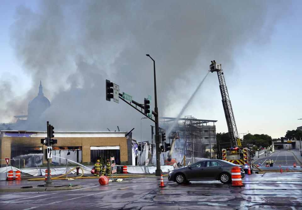 Firefighters battle a fire in downtown St. Paul, Minn., that has engulfed a building that was under construction on Tuesday, Aug. 4, 2020. There were no reports of injuries and there was no immediate word about the possible cause of the fire. (David Joles /Star Tribune via AP)