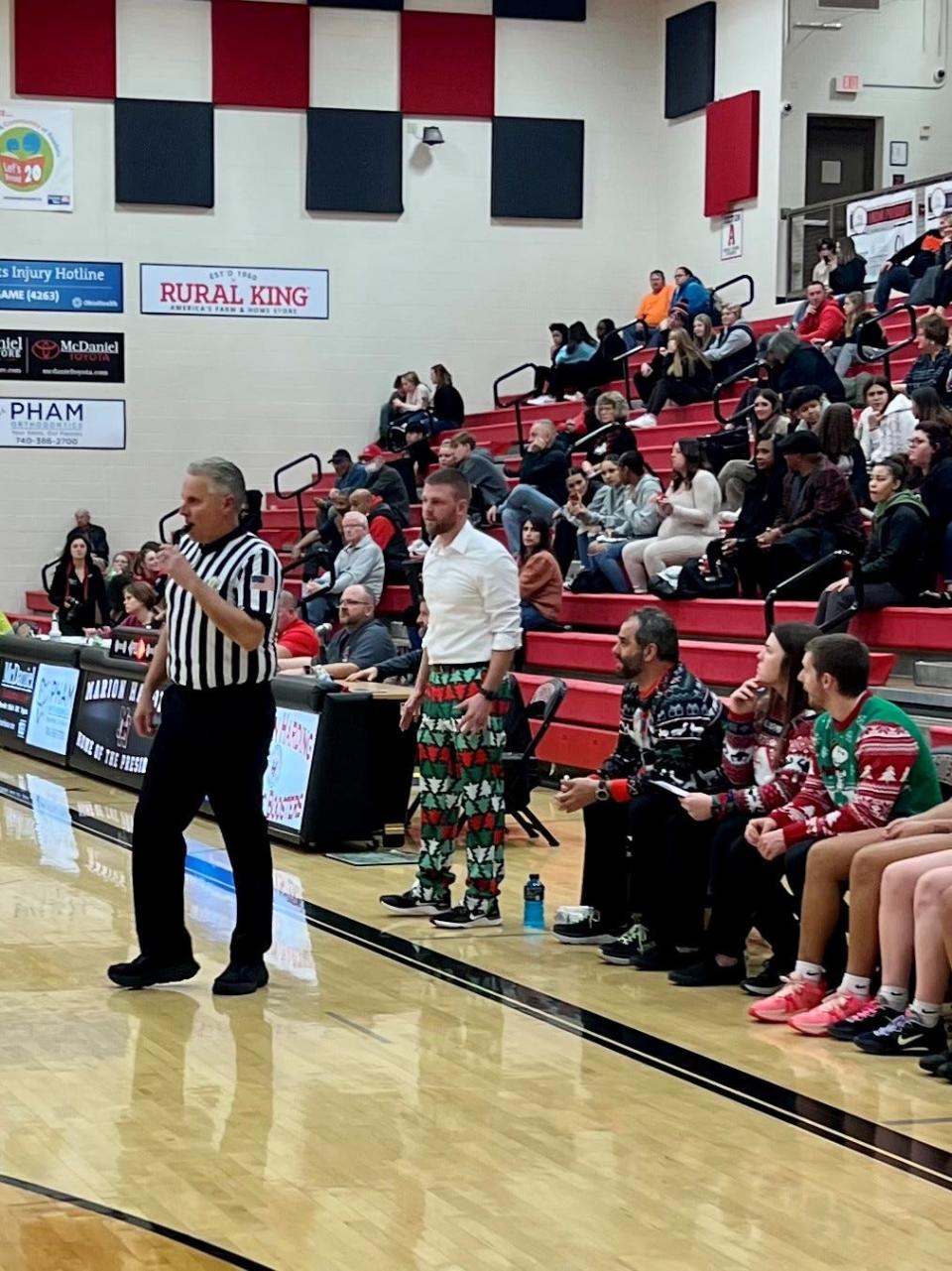 Marion Harding head coach Cory White shed the ugly Christmas suit coat in the second quarter, while his assistants wear ugly Christmas sweaters during Thursday night's Mid Ohio Athletic Conference girls basketball game at Marion Harding.