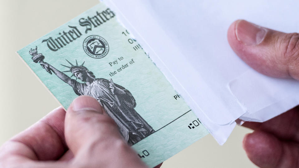 Men hands holding a US Government Treasury check.